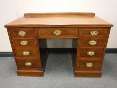 A Victorian mahogany and satinwood inlaid twin pedestal desk, fitted nine drawers, width 122cm.