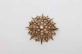 A diamond and seed pearl star brooch.