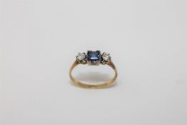 An 18ct gold two stone diamond and sapphire ring, size N, 2g.