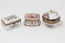 A group of three continental porcelain lidded trinket boxes,