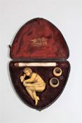 A 19th century carved erotic Meerschaum and ivory pipe, in case.