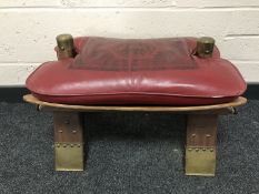 A mid 20th century camel stool with brass mounted feet, length 62cm.