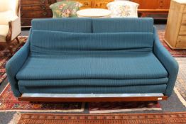 A mid 20th century two seater bed settee on teak frame.
