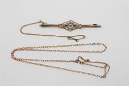 A 15ct gold aquamarine bar brooch set with seed pearls, 3.8g, together with a safety chain.