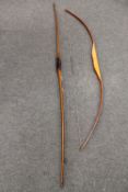 A longbow, together with another bow.