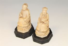 A pair of 19th century Chinese carved ivory figures of an Emperor and Empress, on wooden bases,