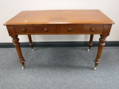 An early Victorian mahogany writing table, fitted two drawers,