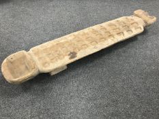 A carved African gaming board.