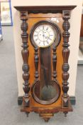 A 19th century mahogany cased Vienna wall clock with pendulum and two weights.