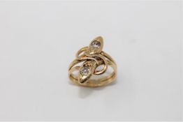 A diamond set snake ring, two entwined serpents forming two bands,