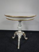 A 19th century style cream and gilded circular pedestal table.