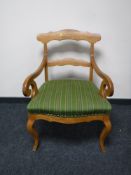 A 19th century walnut armchair upholstered in green striped fabric width 63cm.