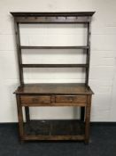 A George III oak dresser fitted with two drawers and plate rack above, width 107cm.