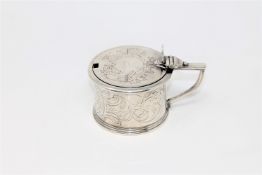 A Georgian drum mustard pot with ornate design and family crest, with blue glass liner,