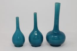 A graduated trio of 19th century Chinese bottle vases on turquoise ground, height 23 cm.