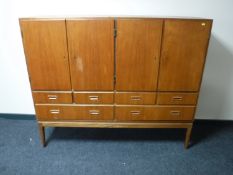 A mid 20th century teak sideboard, fitted with six drawers, width 154cm.