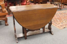 An oak drop leaf table, length opened 136cm.