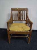A 19th century oak armchair with floral carved back detail, width 58cm.