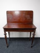 A 19th century mahogany tea table on turned legs, width 93cm.