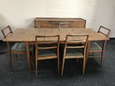 A mid 20th century teak eight piece dining room suite, comprising of low sideboard (width 152cm),