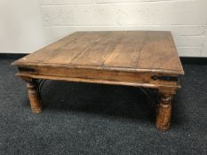 A contemporary hardwood iron bound low table, width 98cm.