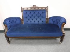 A Victorian oak button-back settee, on carved legs terminating in ceramic castors, width 186cm.