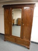 A Victorian mahogany mirror door wardrobe, raised on ogee bracket feet, width 153cm.