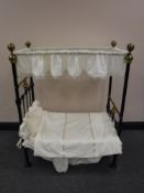 A Victorian cast iron and brass doll's canopy bed, length 89cm.