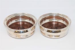A pair of Britannia Jubilee silver bottle coasters by Garrard, London 1977.