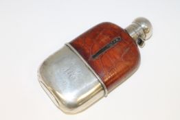 A silver and leather mounted glass hip flask.
