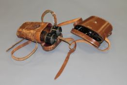 A pair of WWI military issue binoculars in leather case,