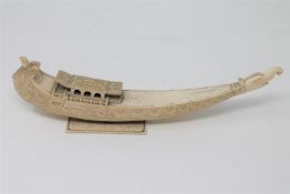 A 19th century Chinese carved ivory model of a junk boat, length 31cm.