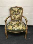 A 19th century style carved walnut armchair upholstered in floral fabric, width 64cm.