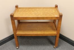 An Albert 'Eagleman' Jeffray oak two-tier serving trolley, raised on castors,