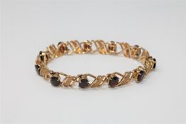 A 9ct gold garnet set bracelet,
