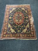 A Persian rug on red and indigo ground, 198cm by 141cm.