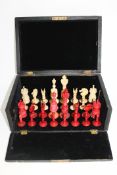 A 19th century white and stained ivory chess set, kings 11.