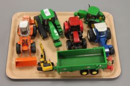 A collection of die-cast farm vehicles including John Deere tractor etc.