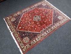 A Khamseh rug, with a central strawberry medallion decorated with flora and fauna, 210cm by 153cm.