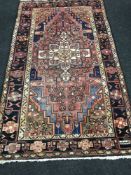 A Heriz design rug, 236cm by 142cm.