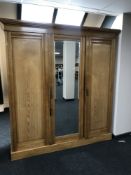 A 19th century ash triple door mirror door wardrobe, width 192cm.