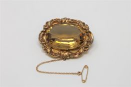 A Victorian yellow metal brooch set with a large citrine.