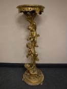 A 19th century gilt and gesso torchere decorated with putti, height 127cm.