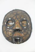 An African Baluba mask with metal inlay and beadwork decoration, height 27cm.