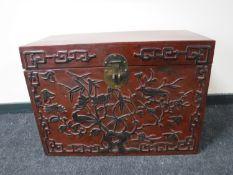 A Chinese lacquered storage chest, the front panel decorated with vines and birds, width 80cm.