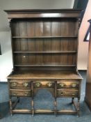 An early 20th century oak farmhouse dresser in the Georgian style, width 138cm.