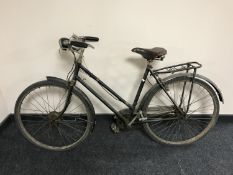 A mid 20th century all steel Raleigh shopping bike with wicker basket.