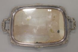 A large early 20th century silver plated butler's tray on squirrel square feet, width 77 cm.