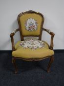 A continental walnut salon chair upholstered in floral fabric, width 58cm.