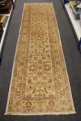 A Persian design runner on sand ground, 294cm by 83cm.